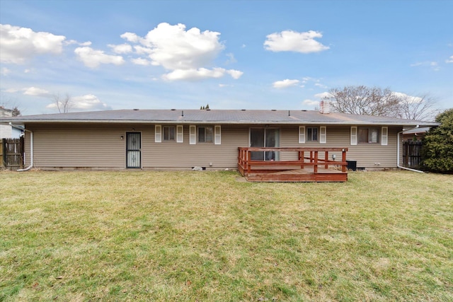 back of house featuring a yard, fence, and a deck