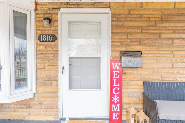 entrance to property with brick siding