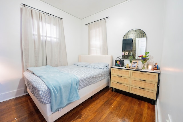 bedroom with dark wood-style floors and baseboards