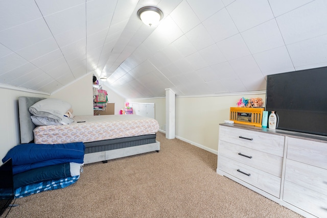 bedroom with lofted ceiling, light colored carpet, and baseboards
