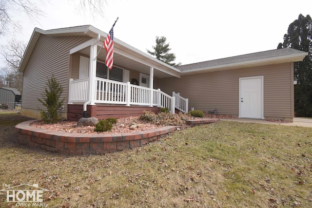 ranch-style home with a porch and a front lawn