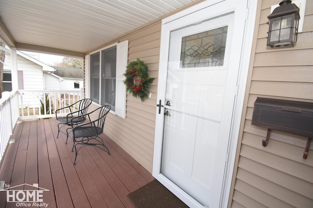 view of exterior entry with a porch