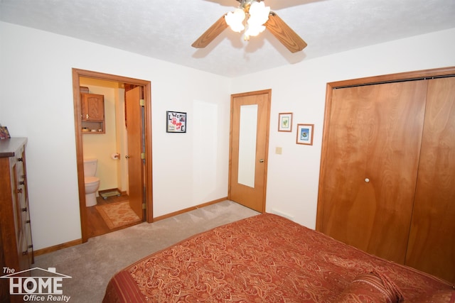 carpeted bedroom featuring a ceiling fan, baseboards, a closet, and ensuite bathroom