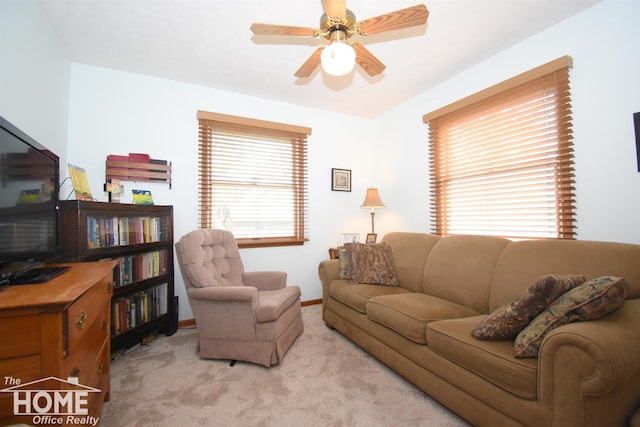 living room with light carpet, ceiling fan, and baseboards