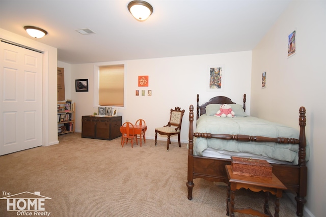 bedroom with light carpet, visible vents, and baseboards