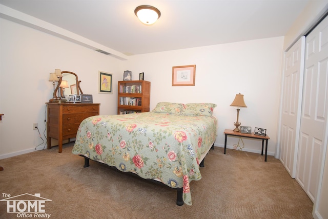 bedroom with carpet, a closet, and baseboards