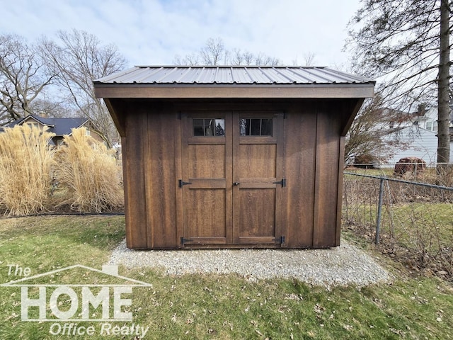 view of shed featuring fence