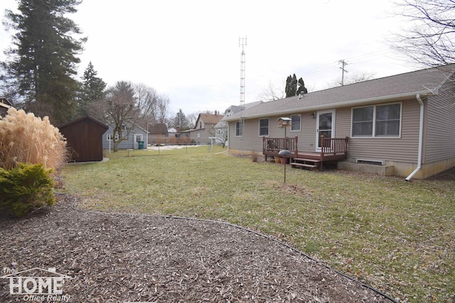 view of yard with a storage unit, an outbuilding, and a wooden deck