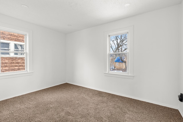 unfurnished room featuring recessed lighting, carpet flooring, a wealth of natural light, and baseboards