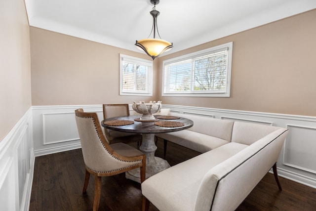 dining room with dark wood-style floors and wainscoting