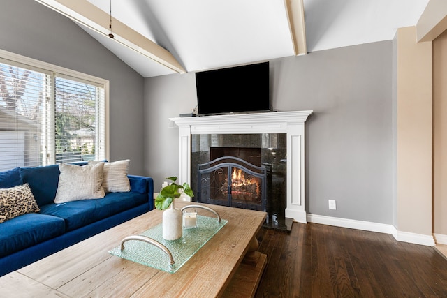 living room with baseboards, wood finished floors, a fireplace, and vaulted ceiling