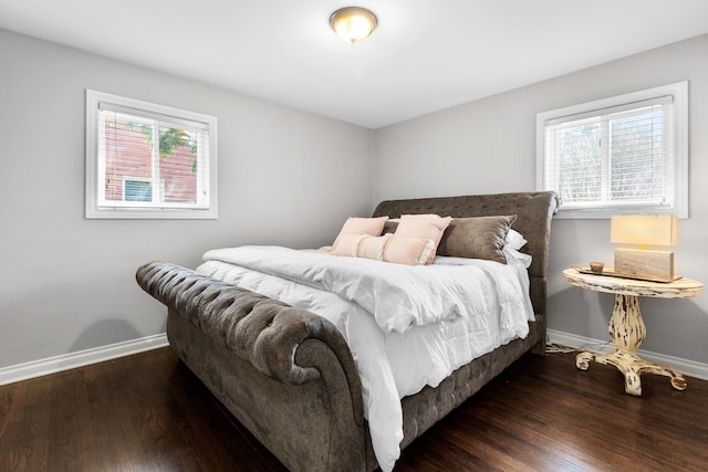 bedroom featuring baseboards and hardwood / wood-style flooring