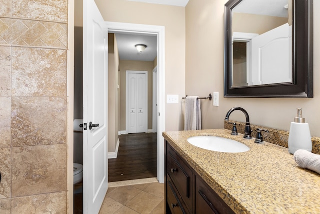 bathroom with vanity, toilet, and tile patterned flooring