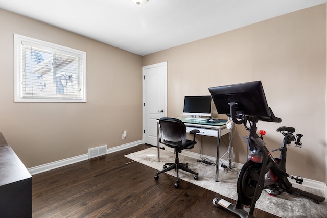 office featuring wood finished floors, visible vents, and baseboards