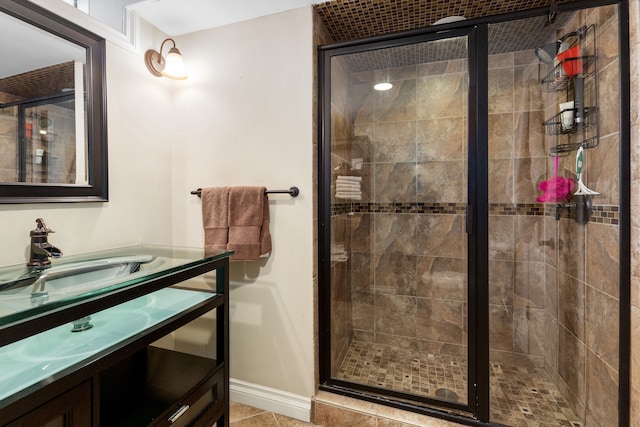 full bathroom featuring a shower stall, vanity, and baseboards