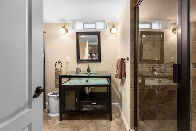 full bathroom featuring vanity, baseboards, and a stall shower