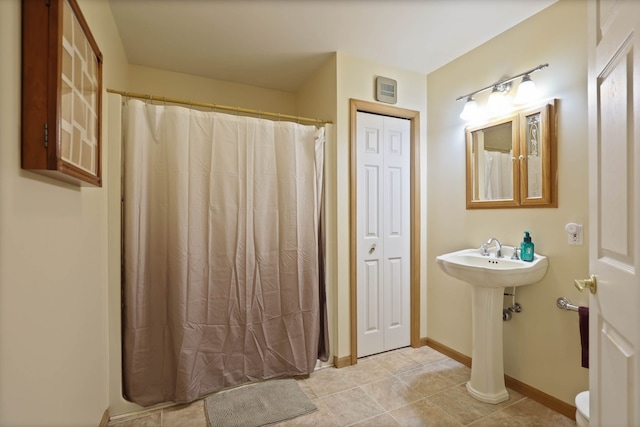 full bathroom featuring baseboards