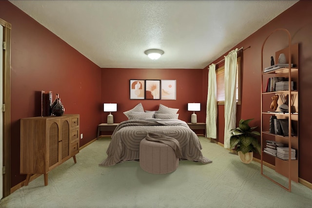 bedroom featuring a textured ceiling and baseboards