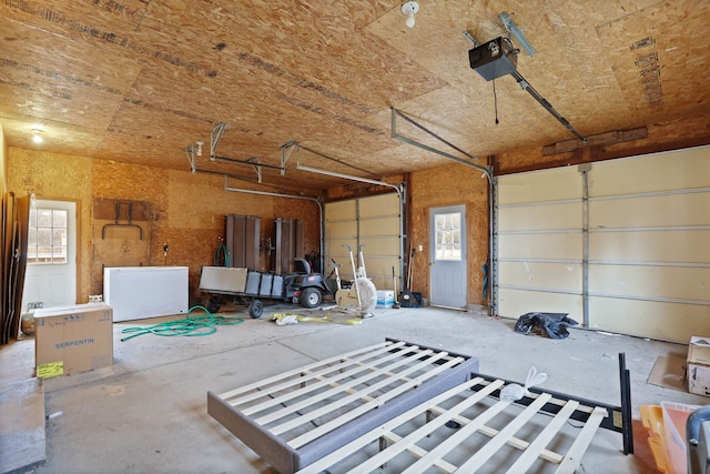 garage with refrigerator and a garage door opener