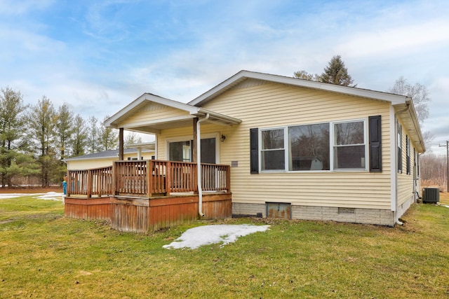 rear view of property with a deck, cooling unit, a lawn, and crawl space