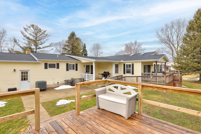 wooden terrace featuring a yard and central AC