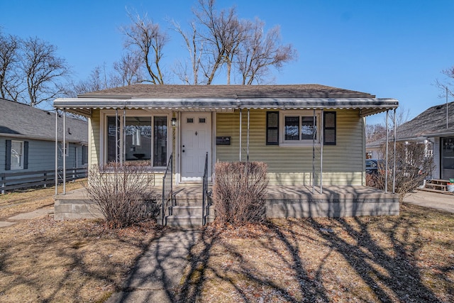 bungalow featuring covered porch and a shingled roof