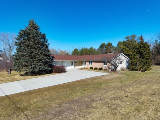 single story home featuring concrete driveway, a garage, and a front yard