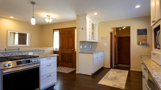 kitchen featuring dark wood-type flooring, white cabinets, glass insert cabinets, and stainless steel gas range oven