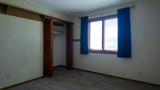 unfurnished bedroom featuring a closet, baseboards, carpet, and visible vents