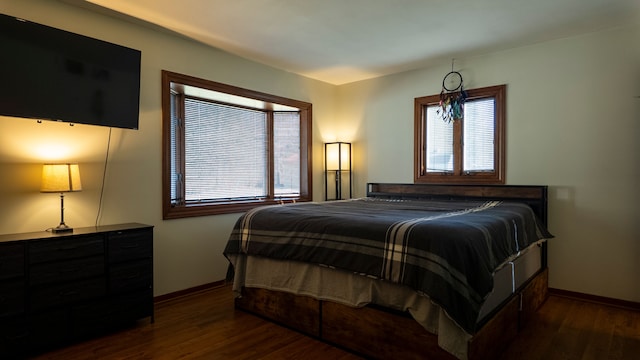 bedroom with baseboards and wood finished floors