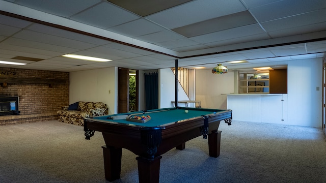 game room featuring billiards, brick wall, carpet floors, a fireplace, and a paneled ceiling