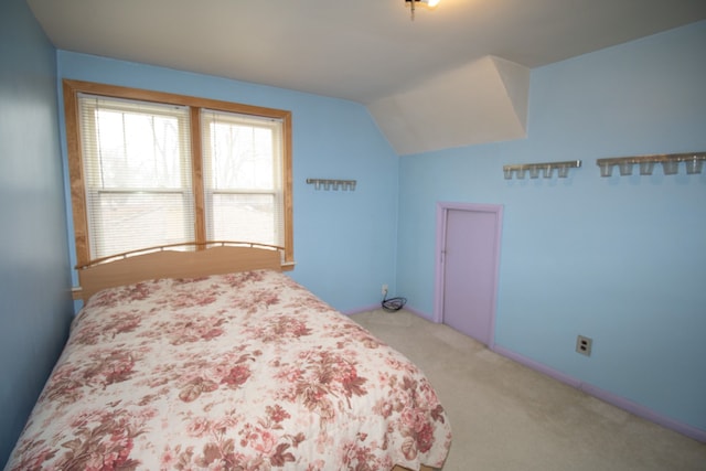 carpeted bedroom featuring lofted ceiling