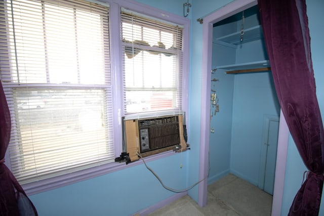 bedroom with cooling unit and a closet