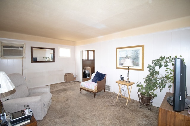 carpeted living room with visible vents and an AC wall unit