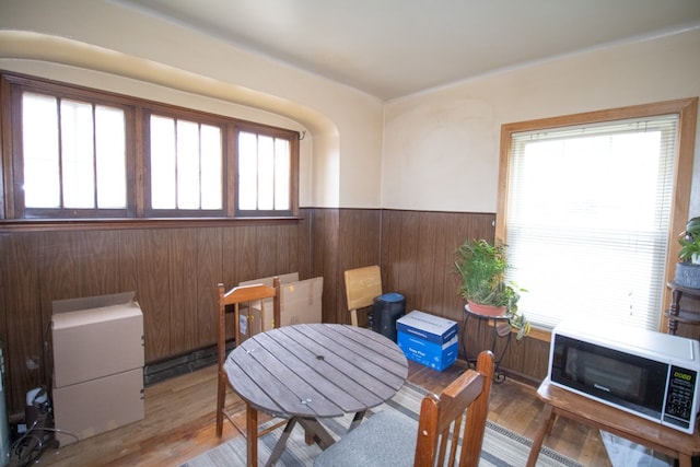 sitting room featuring wainscoting, wood finished floors, and wooden walls