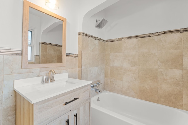 full bathroom with shower / bath combination, visible vents, tile walls, and vanity