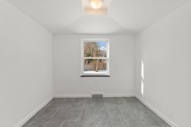 spare room with visible vents and baseboards