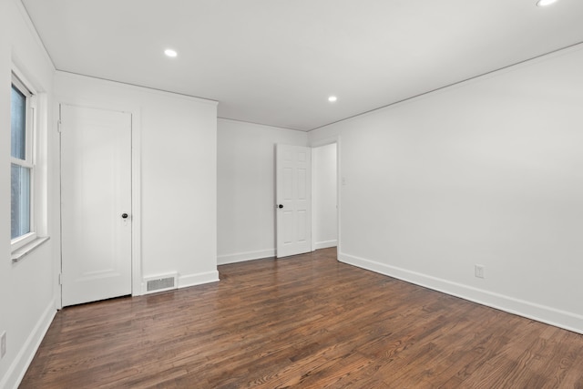 unfurnished bedroom with baseboards, dark wood-style flooring, visible vents, and recessed lighting