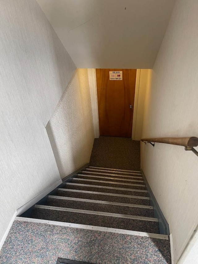 stairs featuring a textured wall