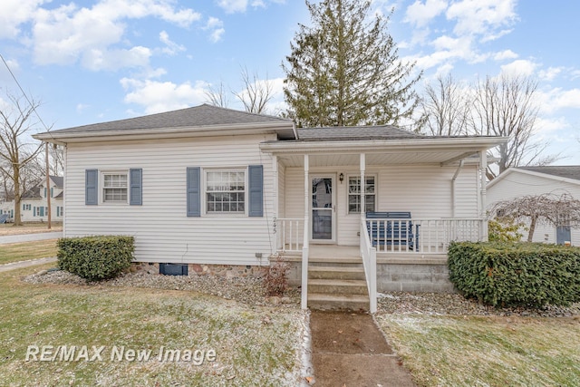 bungalow-style home with covered porch and roof with shingles