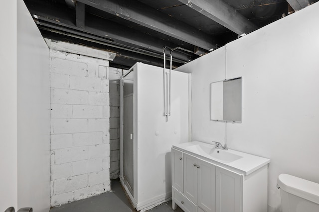 bathroom featuring toilet, concrete flooring, and vanity