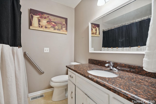 bathroom featuring visible vents, toilet, vanity, tile patterned flooring, and baseboards