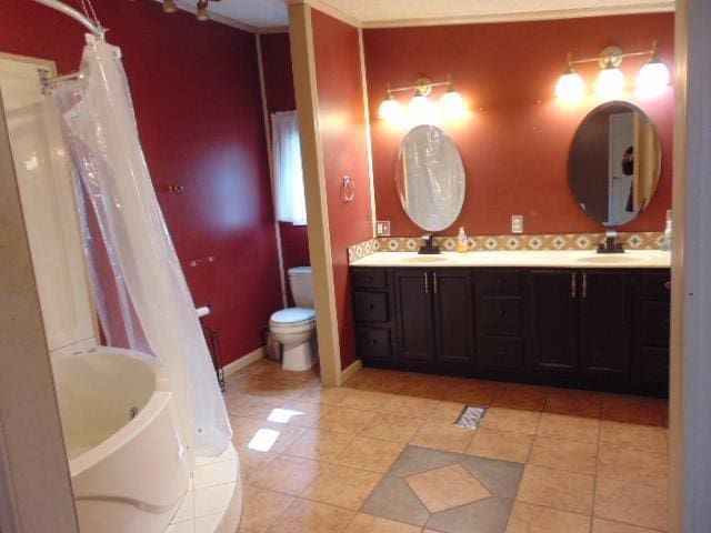 full bathroom with double vanity, a sink, toilet, and a bathing tub