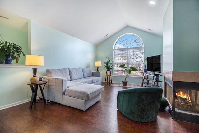 living room featuring wood-type flooring, baseboards, vaulted ceiling, and a multi sided fireplace