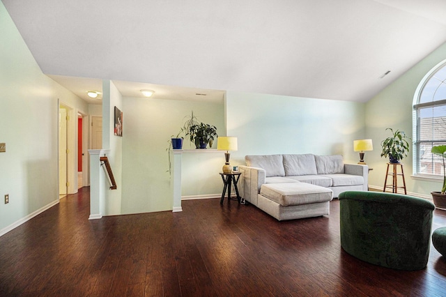 living room featuring baseboards, visible vents, vaulted ceiling, and hardwood / wood-style floors