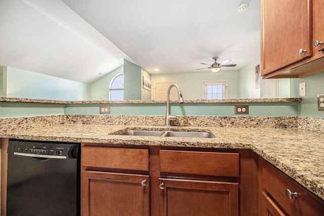 kitchen featuring light stone counters, a sink, a ceiling fan, black dishwasher, and vaulted ceiling