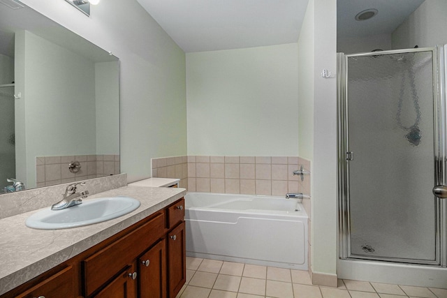 full bathroom with a bath, tile patterned flooring, a shower stall, and vanity