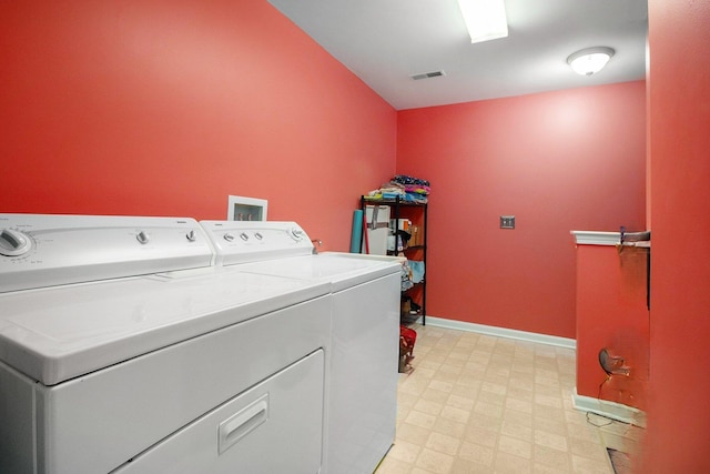 laundry room featuring laundry area, visible vents, baseboards, light floors, and washing machine and dryer