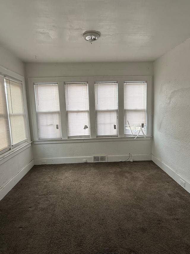 unfurnished sunroom featuring visible vents and a wealth of natural light