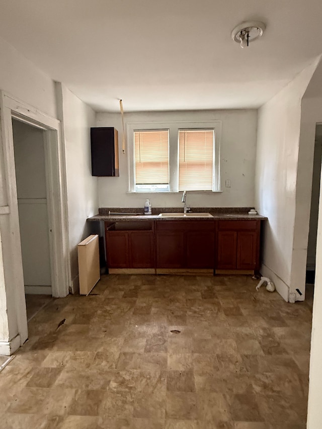 kitchen featuring a sink and brown cabinets